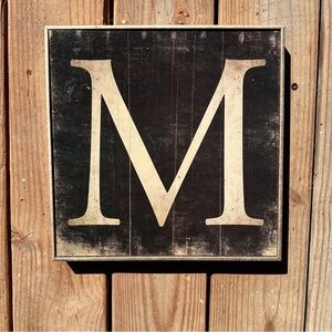 Antique-looking “M” Sign